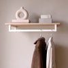 étagère en chêne classique équipée d'une tringle à vêtements minimaliste blanc mat pour suspendre vestes, manteaux et ranger des vases ou livres
